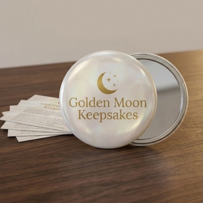Round mirror with 'Golden Moon Keepsakes' branding on a wooden surface