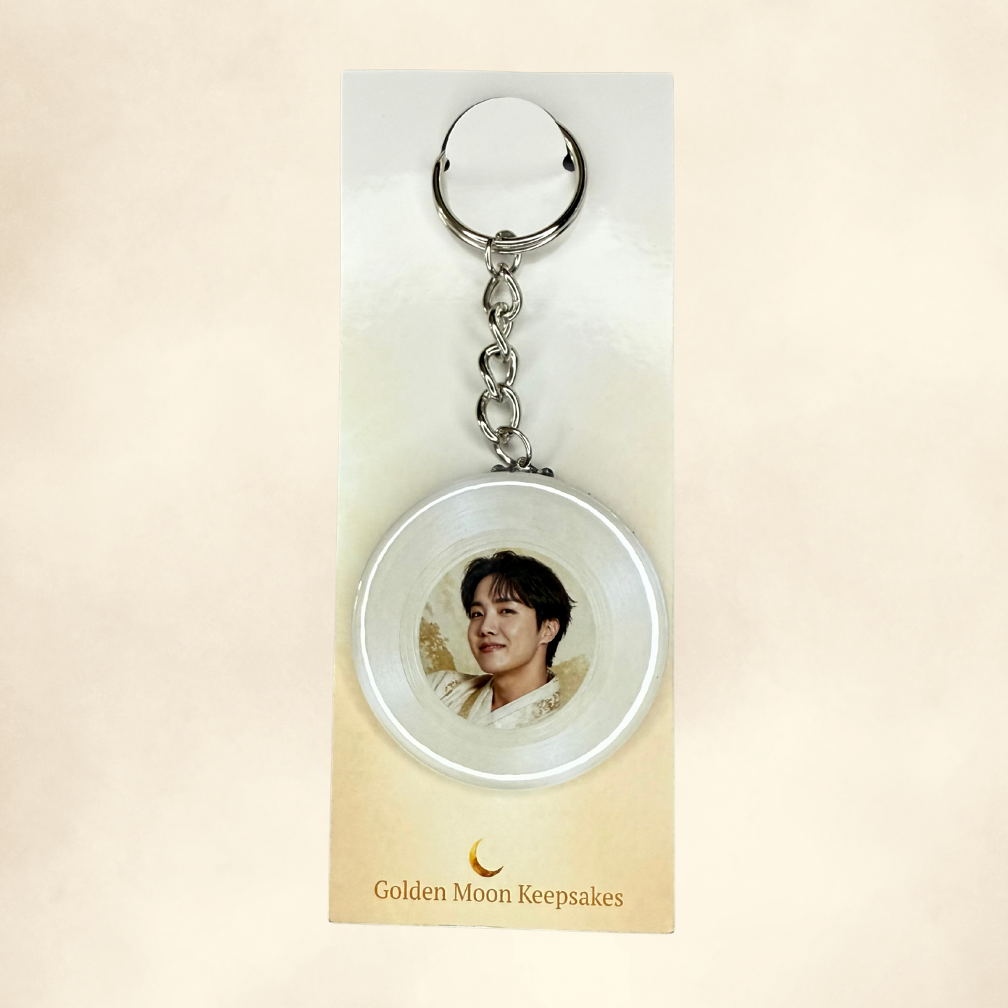 Keychain with a circular pendant featuring a portrait on a beige card with 'Golden Moon Keepsakes' branding.