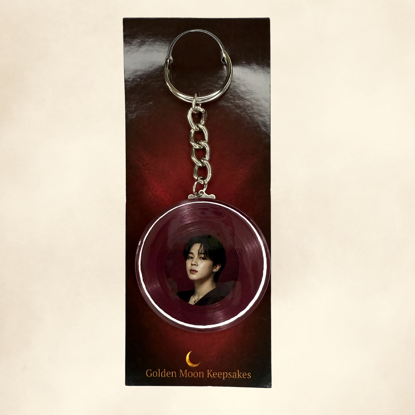 Keychain with circular design featuring a portrait on a dark background, branded 'Golden Moon Keepsakes'.