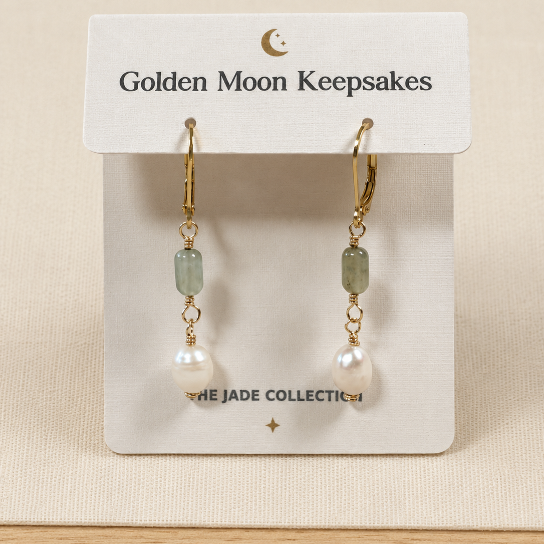 A pair of gold hoop earrings with light green rectangular beads, small gold chain links, and white pearl drops, displayed on a white card labeled Golden Moon Keepsakes.