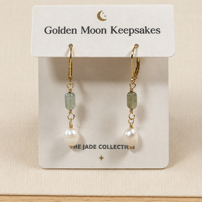 A pair of gold hoop earrings with light green rectangular beads, small gold chain links, and white pearl drops, displayed on a white card labeled Golden Moon Keepsakes.