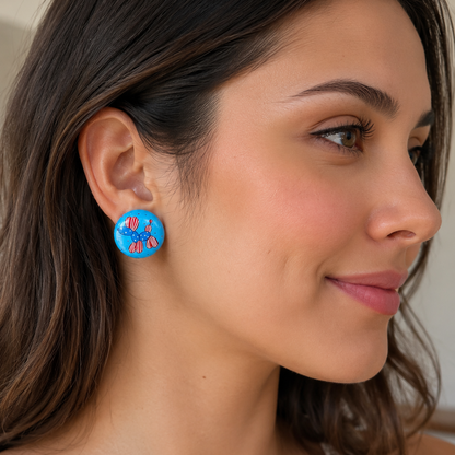 Woman wearing blue earrings with a parotic balloon dog design, close-up of ear.